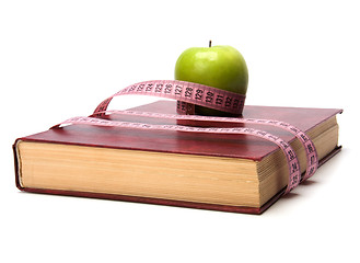 Image showing tape measure wrapped around book isolated on white background