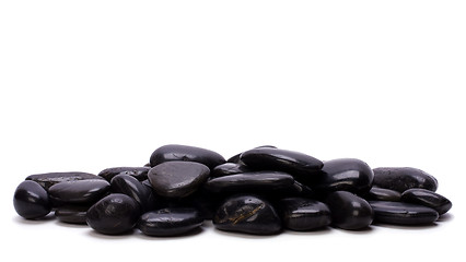 Image showing Heap of black pebbles isolated on white background