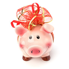 Image showing Christmas deposit concept. Piggy bank with festive bow isolated 