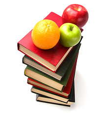 Image showing book stack with fruits isolated on white background 