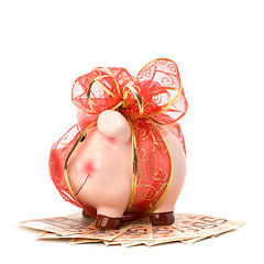 Image showing Christmas deposit concept. Piggy bank with festive bow isolated 