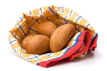 Image showing fresh warm rolls over kitchen towel isolated on white background