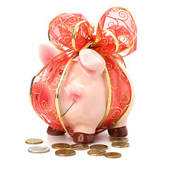 Image showing Christmas deposit concept. Piggy bank with festive bow isolated 