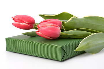 Image showing gift with pink tulips  isolated on white background