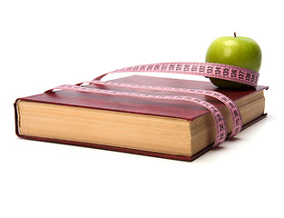 Image showing tape measure wrapped around book isolated on white background