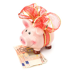 Image showing Christmas deposit concept. Piggy bank with festive bow isolated 