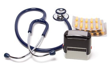 Image showing stethoscope, tablets  and doctor seal isolated on white backgrou