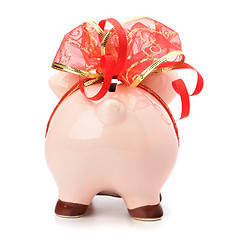 Image showing Christmas deposit concept. Piggy bank with festive bow isolated 