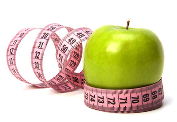 Image showing  tape measure wrapped around the apple isolated on white backgro