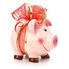 Image showing Christmas deposit concept. Piggy bank with festive bow isolated 