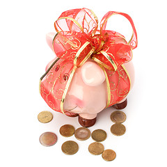 Image showing Christmas deposit concept. Piggy bank with festive bow isolated 