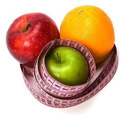 Image showing  tape measure wrapped around fruits isolated on white background