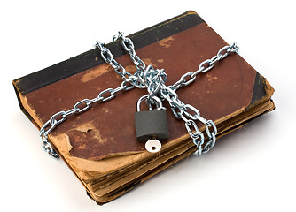 Image showing tattered book with chain and padlock isolated on white backgroun