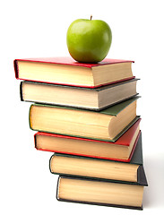 Image showing book stack with apple isolated on white background 