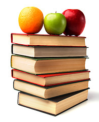 Image showing book stack with fruits isolated on white background 