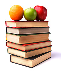 Image showing book stack with fruits isolated on white background 