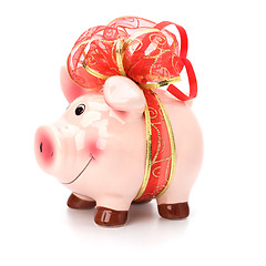 Image showing Christmas deposit concept. Piggy bank with festive bow isolated 