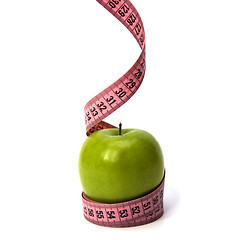 Image showing  tape measure wrapped around the apple isolated on white backgro