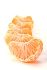 Image showing peeled mandarin segments isolated on white background