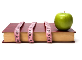 Image showing tape measure wrapped around book isolated on white background