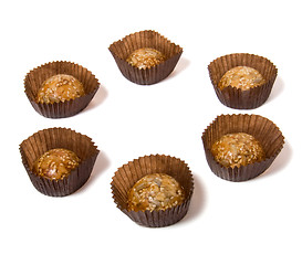 Image showing Caramel sweets with sunflower seeds isolated on white 