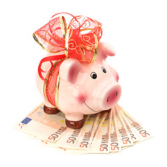 Image showing Christmas deposit concept. Piggy bank with festive bow isolated 