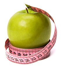 Image showing  tape measure wrapped around the apple isolated on white backgro