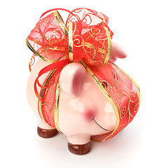 Image showing Christmas deposit concept. Piggy bank with festive bow isolated 