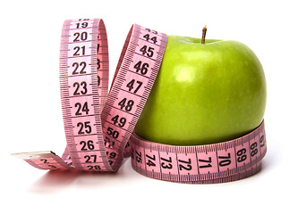 Image showing  tape measure wrapped around the apple isolated on white backgro