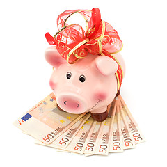 Image showing Christmas deposit concept. Piggy bank with festive bow isolated 