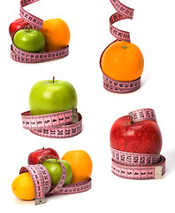 Image showing  tape measure wrapped around fruits isolated on white background