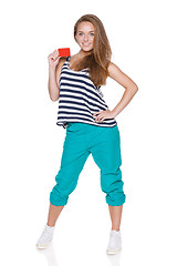 Image showing Positive teen girl smiling showing credit card