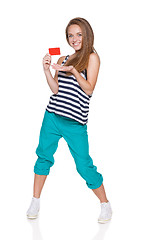 Image showing Positive teen girl smiling showing credit card