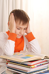 Image showing Young boy with books