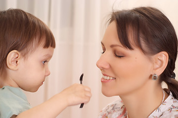 Image showing Daughter making up her mother