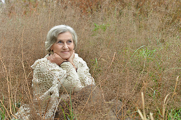 Image showing Smiling senior woman in autumn