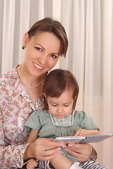 Image showing Mom and daughter reading