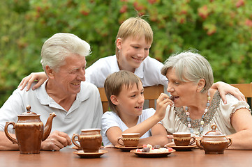 Image showing Family drinking tea outdoors