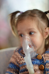 Image showing Little girl with inhaler