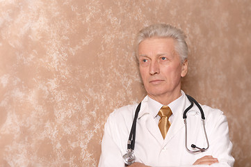 Image showing senior doctor on brown.