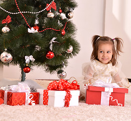 Image showing Little girl with Christmas gifts