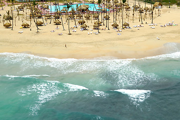 Image showing Exotic beach with palms and parasols