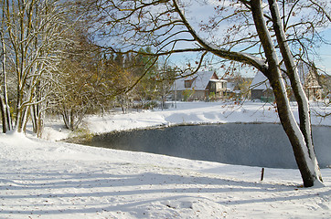 Image showing Autumn landscape with snow by a pond in rural  