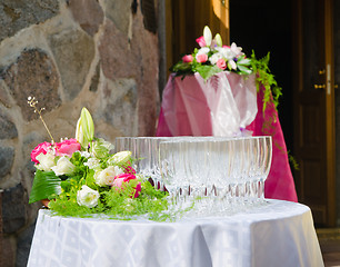 Image showing Bouquet of flowers and wine glasses for a wedding table 