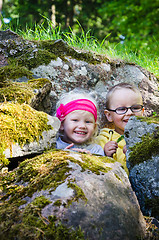 Image showing Young children, the boy with the girl hid among the rocks