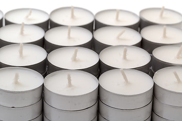 Image showing Rows of white wax tea light candles