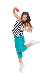 Image showing Excited teen girl smiling showing credit card