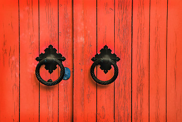Image showing Red wooden door with round handles