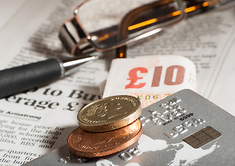 Image showing Glasses, coins, credit cards and banknotes on newspaper