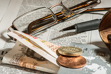 Image showing Glasses, coins, credit cards and banknotes on newspaper